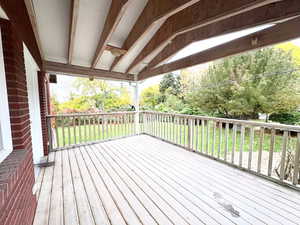 Deck featuring a yard and view of scattered trees