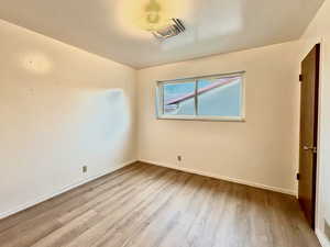 Spare room featuring light wood-style flooring