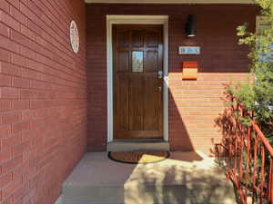 Entrance to property with brick siding