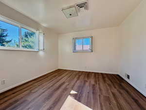 Unfurnished room with dark wood-style floors