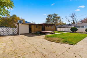 Rear view of property with a gate and a wooden deck