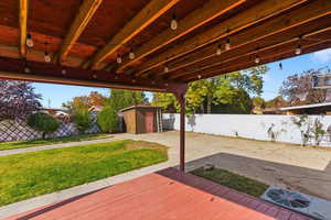 Wooden deck with a fenced backyard and a shed
