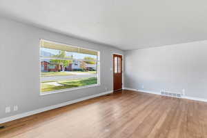 Foyer entrance featuring light wood-style floors and baseboards