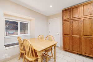 Dining space featuring light tile patterned flooring and recessed lighting