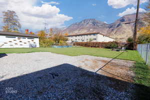 Fenced backyard featuring a mountain view