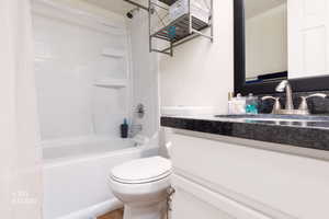 Bathroom featuring shower / bath combination with curtain and vanity