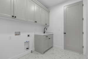 Laundry area featuring washer hookup, electric dryer hookup, and cabinet space
