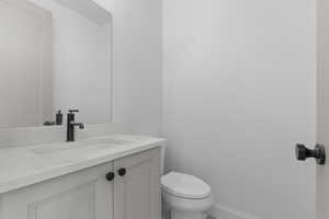 Half bath with vanity and toilet