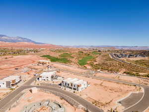 Aerial view of property's location featuring a mountain backdrop and a desert landscape
