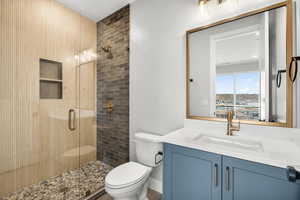 Bathroom with vanity and a stall shower