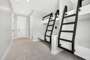 Hall featuring light colored carpet and recessed lighting