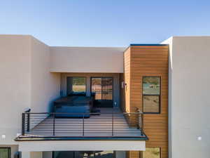 Entrance to property with stucco siding