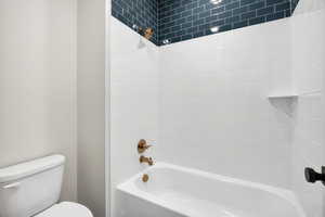 Full bathroom featuring shower / bathtub combination and toilet