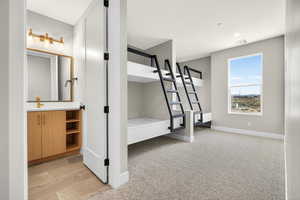Unfurnished bedroom featuring light carpet and baseboards