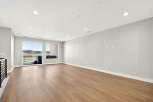 Unfurnished living room featuring light wood finished floors and recessed lighting