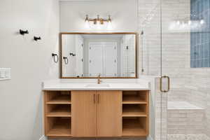 Bathroom with a stall shower and vanity