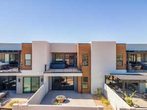 Back of property featuring a patio and stucco siding