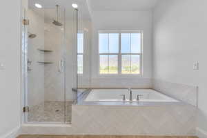 Full bathroom with a bath, a stall shower, and recessed lighting
