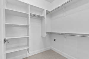 Spacious closet with light colored carpet