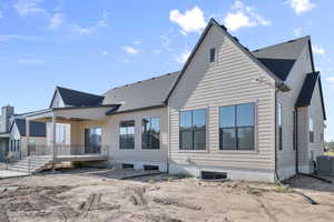 Back of house with a shingled roof
