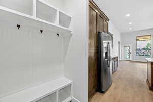 Mudroom featuring light wood-style flooring and recessed lighting