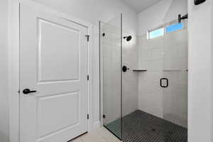 Full bath with a stall shower and light tile patterned floors