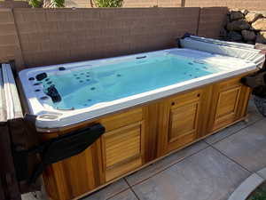 Miscellaneous room with a jacuzzi and tile patterned floors