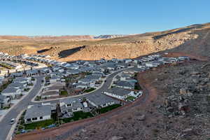 Aerial overview of property's location featuring nearby suburban area and a mountain backdrop