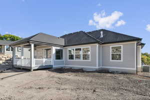 Rear view of property with roof with shingles and a wooden deck