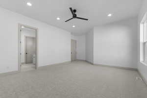 Unfurnished bedroom featuring light carpet, recessed lighting, and a ceiling fan