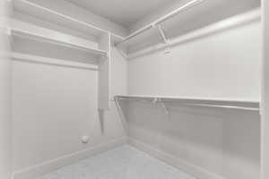 Spacious closet featuring carpet flooring