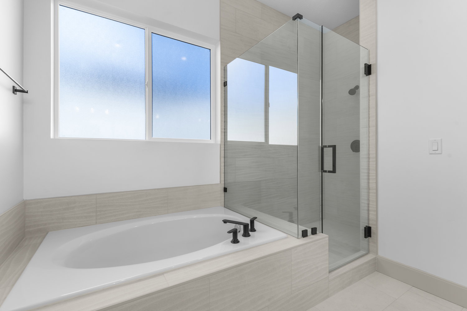 Full bath featuring a bath, a stall shower, and tile patterned flooring