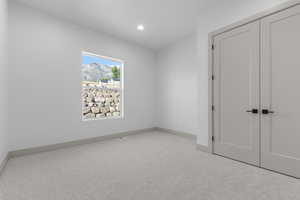 Unfurnished bedroom featuring carpet, a closet, and recessed lighting