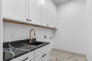 Washroom featuring cabinet space, washer hookup, and hookup for an electric dryer