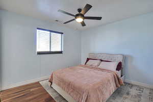 Bedroom featuring wood finished floors and a ceiling fan