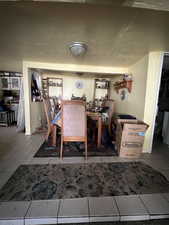 Tiled dining space featuring a textured ceiling