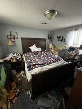 Bedroom featuring a textured ceiling