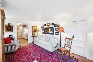 Living room with light wood finished floors and ornamental molding