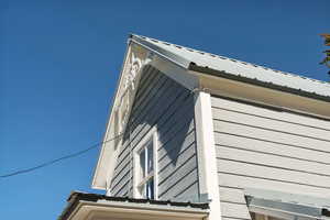 View of side of home featuring a metal roof