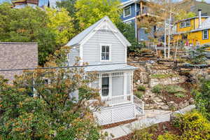 View of side of home with a metal roof and a porch