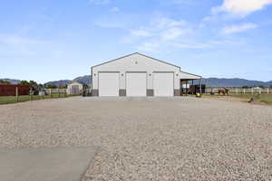 Detached garage with a mountain view and a view of rural / pastoral area