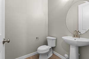 Bathroom with baseboards and wood finished floors