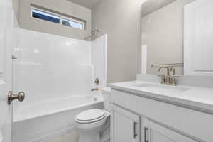 Full bath featuring shower / tub combination, vanity, and light tile patterned floors