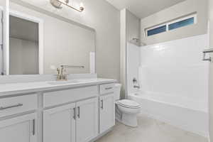 Full bath featuring tub / shower combination, vanity, and light marble finish flooring