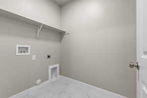 Laundry room with marble look tile flooring, hookup for an electric dryer, and washer hookup