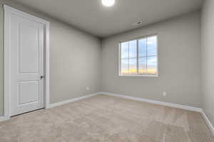 Empty room with light carpet and a mountain view