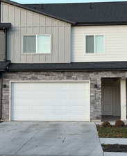 Front of Townhome featuring 2 car garage and  double-wide concrete driveway