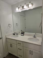 Full bath with double vanity connected to owners' bedroom