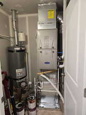 Utility room with energy efficient heating unit and water heater