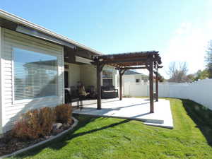 Fenced backyard featuring a pergola and a patio